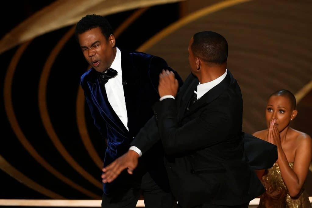 Rapper in a dramatic moment on stage, symbolizing the bold transitions from music fame to business power.