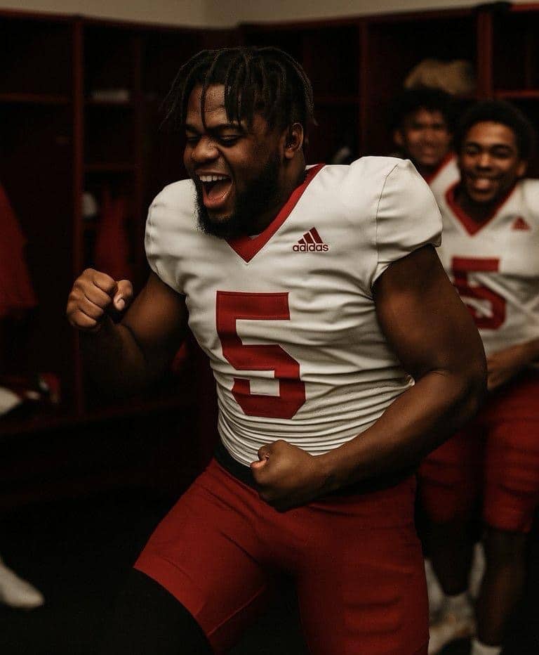 Athlete dancing in locker room with red shorts and dreadlocks